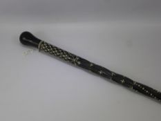 An Antique Ceylonese Ebony and Ivory Inlaid Walking Stick, a large leather crop together with a