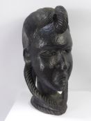 A Hand Carved Sub-Saharan Bust of a Tribal Woman, the woman depicted with elaborate braiding to