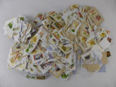 A Quantity of All World Stamps on Paper, mostly South African and Swaziland interest.