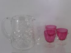 Set of Six Cut Glass Water Glasses and Jug, together with three cranberry custard glasses.