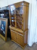 A Contemporary Yew Wood Display Cabinet, with glazed fronted doors and two internal shelves, two