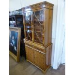 A Contemporary Yew Wood Display Cabinet, with glazed fronted doors and two internal shelves, two