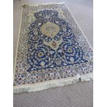A Hand Knotted Persian Wool and Silk Nain Rug, approx 206 x 116 cms.