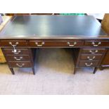 An Edwardian Oak Office Desk, four short drawers to either side and one long central drawer, brass