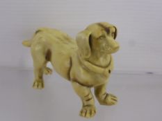 An Antique Porcelain Figure of a Dachshund, approx 10 x 6 cms.