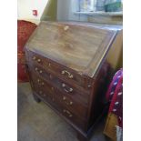 An Antique Writing Bureau, five graduated drawers, drop front with fitted burgundy leather interior,