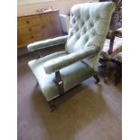 An Antique Arm Chair, with turned legs and mahogany frame covered in celadon green velvet.