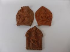 Three Terracotta Wall Plaques, depicting Indian deity, together with a terracotta seated buddha. (