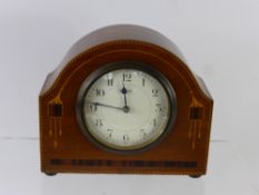 A French Oak and Rosewood Art Deco Mantel Clock, movement stamped S.F.R.A., the clock with