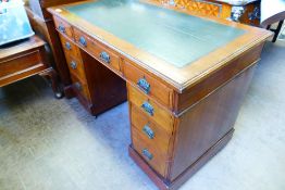 An Edwardian Twin Pedestal Leather Top Desk, with Art Nouveau handles, approx 66 x 104 x 70 cms,