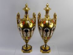 A Pair of Imari Pattern Royal Crown Derby Twin Handled Vases. The vases of ovoid urn form, with