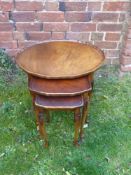 A Nest of Three Oval Oak Tables, on tapered legs. (3)