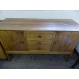 A Gordon Russell Cotswold School Side Board, with three central drawer and cupboards either side,