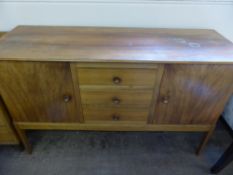 A Gordon Russell Cotswold School Side Board, with three central drawer and cupboards either side,