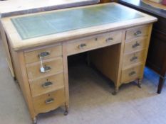 A Pine Edwardian Office Desk, four short drawers to either side and one central drawer, green tooled