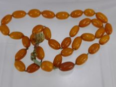 An Antique Chinese Butterscotch Amber Necklace, approx 88 cms long, beads approx 2.5 cms each, on