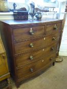 An English Regency Mahogany Bow Fronted Chest of Drawers, two short drawers over three long drawers,