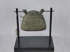 An Antique Bronze South Asian Water Buffalo Bell, raised on a wooden support, approx 11 x 9 cms