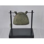 An Antique Bronze South Asian Water Buffalo Bell, raised on a wooden support, approx 11 x 9 cms