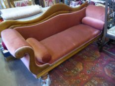 A Victorian Mahogany Sofa, the sofa having one swan shaped arm and back, on turned feet with