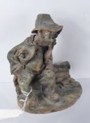Norman Underhill, Studio pottery figure of a character seated on a bench, approx 19 cms high,