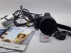 A Sony 8 mp Digital Camera, DSC-H9 15 x optical zoom, complete with accessories including battery,