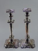 A Pair of Sheffield Plate Rococo Style Candlesticks, approx 32 cms together in a toast rack. (3)