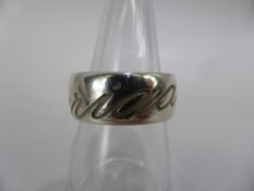 A Solid Silver Clogau 925 Hallmark Ring, the ring inscribed 'Cariad' and having the gold CG motiff