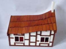 A Hand Crafted Wooden Chalet Style Doll's House, with open plan living and stairway to upstairs