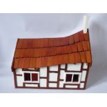 A Hand Crafted Wooden Chalet Style Doll's House, with open plan living and stairway to upstairs