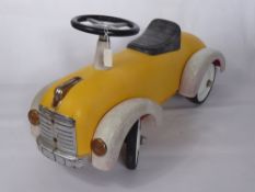 A 1950's Style Child's Car, together with a clockwork train set.