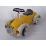 A 1950's Style Child's Car, together with a clockwork train set.