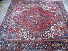 A Vintage Circa 1920's "Heriz" Carpet,, with jewel colours and of geometric design, with label to