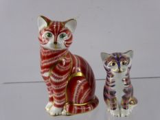 Crown Derby Paperweights, in the form of seated cats, factory marks to base, together with a Poole