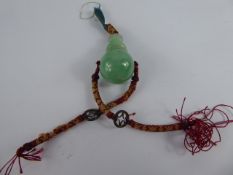 An Antique Chinese Apple Green/Imperial Jade Circular Ball and Carved Finial Pendant, the pendant