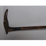 An Antique Mixed Wood Cane, the carved horn handle in the form of a crane.