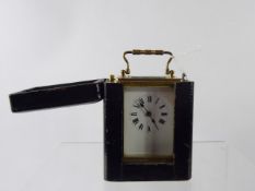 A French Brass Carriage Clock, movement stamped SF, white enamel face, Roman dial, in the original