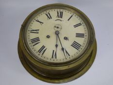 An Antique Brass Wall Mounted Ship's Clock, the clock having white painted face with minute hand,