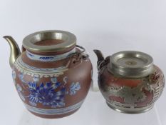Two Chinese 19th Century Terracotta and Metal Overlay Teapots, one depicting dragons the other