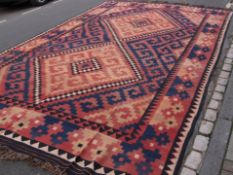 An Afghan Kilim, pink cream and black chequered design, approx 500 x 306 cms.