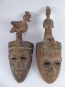 Two Antique Small Ivory Coast Tribal Masks, the first mask with a carved cockerel to the top and the