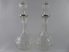 A Pair of Silver Collared Cut Glass Decanters, with the original stoppers.