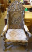 An Antique Oak Baronial Chair, the back rest with profuse decorative carving depicting a