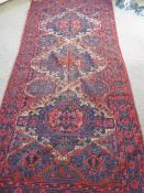 An Antique Caucasian Soumak Carpet, with diamond shaped central ghouls in dark pink and blue with