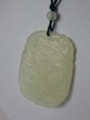 An Antique White Jade / /Hard Stone Pendant Amulet, depicting a dragon, approx 4.5 x 3.5 cms.