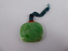 A Chinese Antique Apple Green Circular Form Jade Amulet / Pendant, on fine silk with coloured