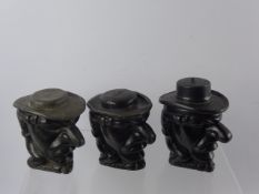 A Trio of Antique Tumbledown Jack Tobacco Jars, one in lead, the other cast aluminium and third cast