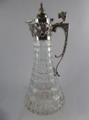 A Silver Topped Cut Glass Flat Bottom Claret Jug, the claret jug decorated with shells and grapes to