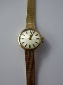A Lady's 9ct Gold Tissot Cocktail Watch, on a 9ct gold ribbed bracelet. The watch having a