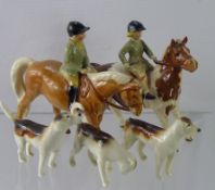 A Group of Beswick Porcelain Figures, including two child hunters and three Beswick hounds. (af) (